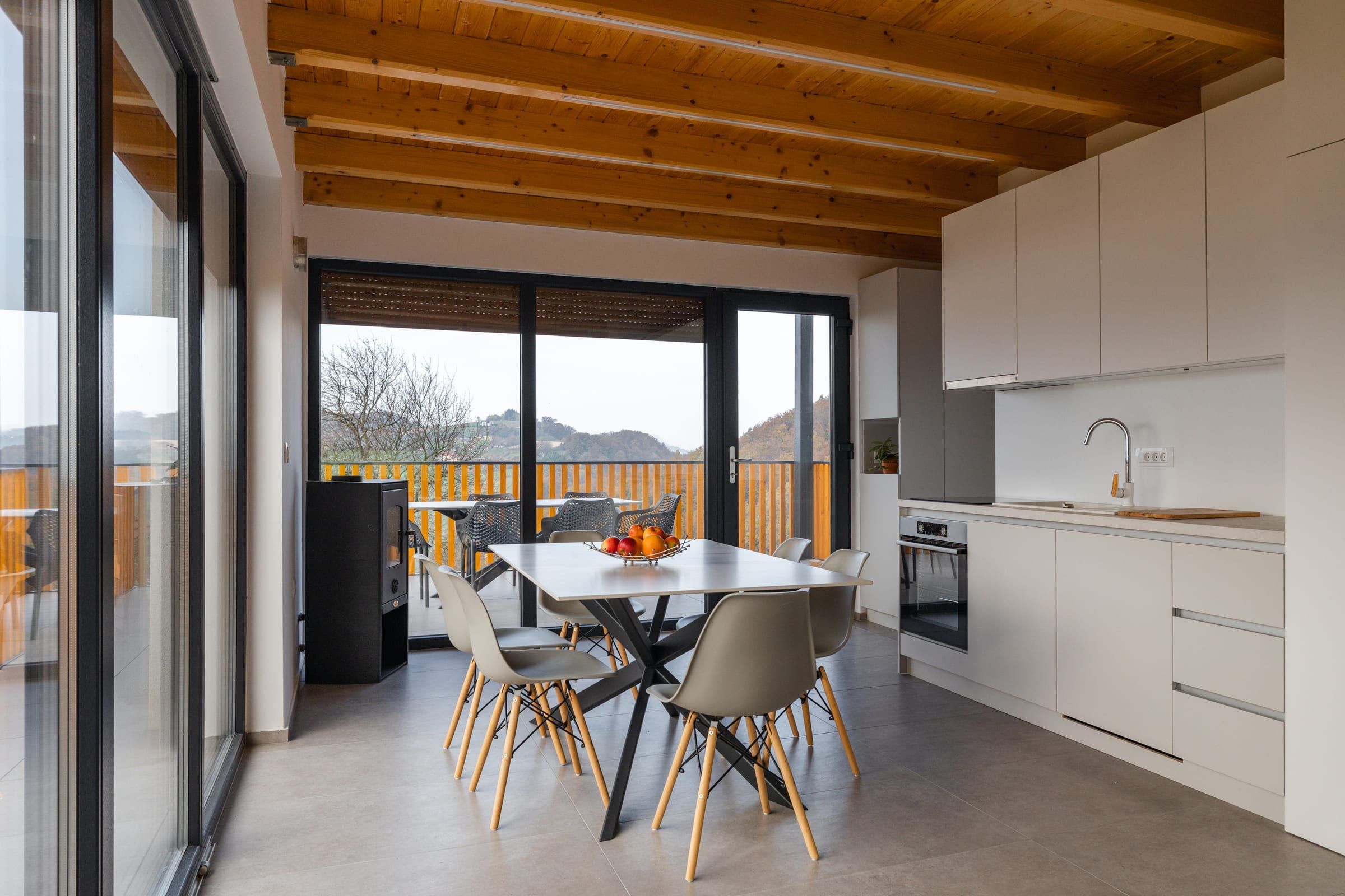The dining table set for six, open to the kitchen and living room.