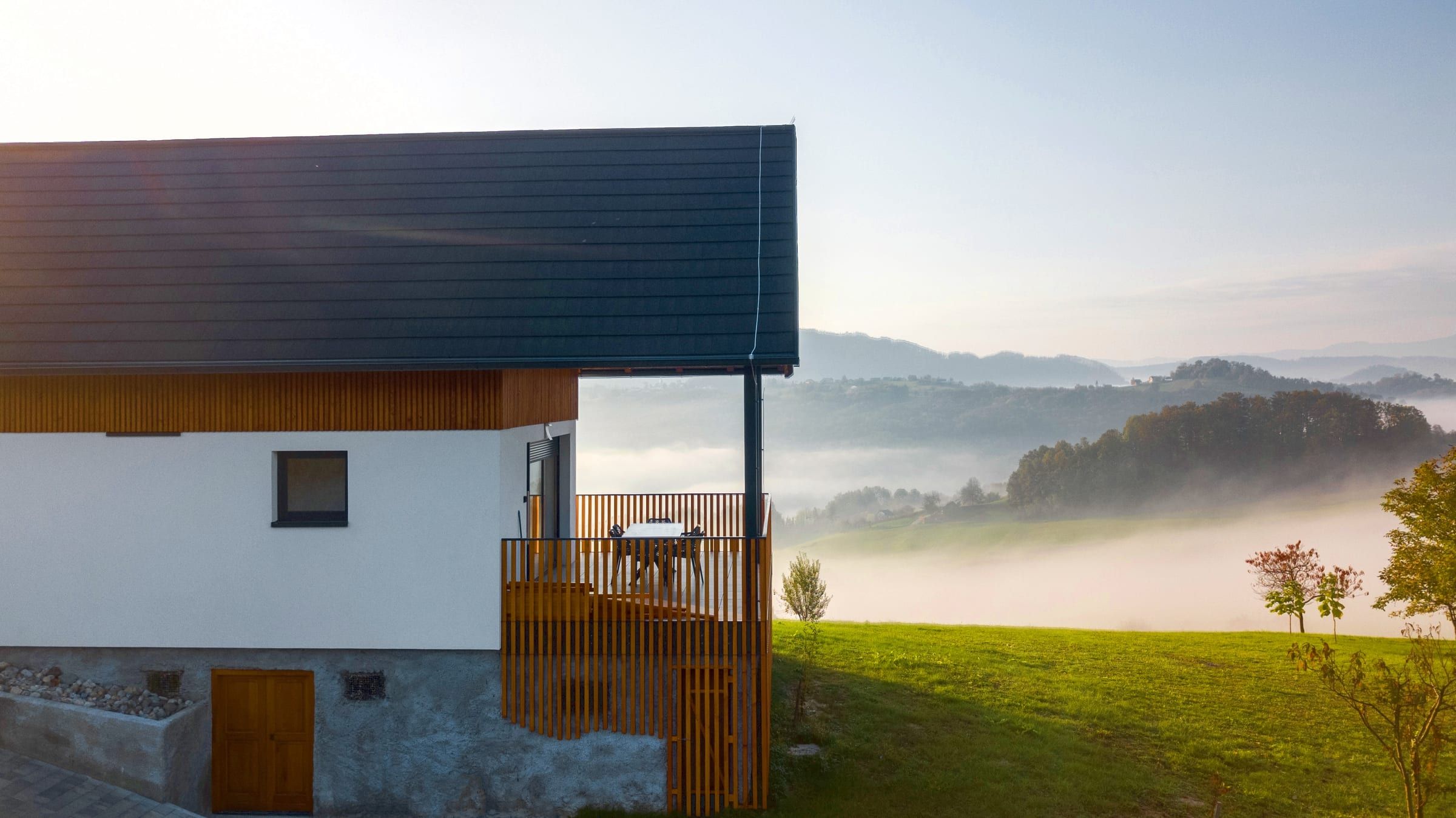 The villa on its hilltop above a mist-filled valley in the early morning light.