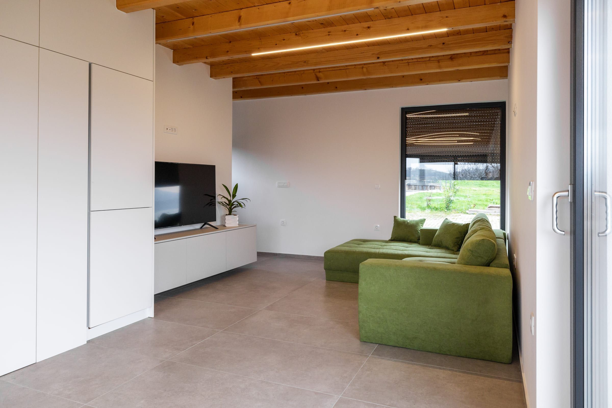 The fully equipped kitchen with the dining table and terrace beyond.